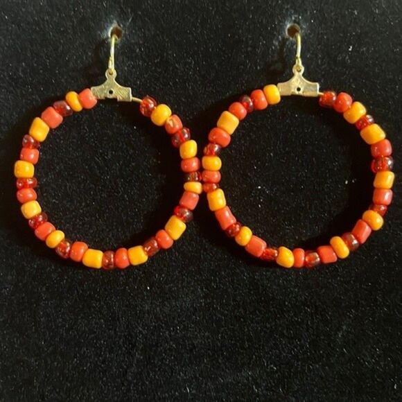 Handcrafted gold tone hoop earrings with orange beading. - Picture 1 of 4
